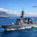 Japanese Maritime Self‑Defense Force destroyer sailing through the blue waters of the Taiwan Strait with allied vessels in the distance.